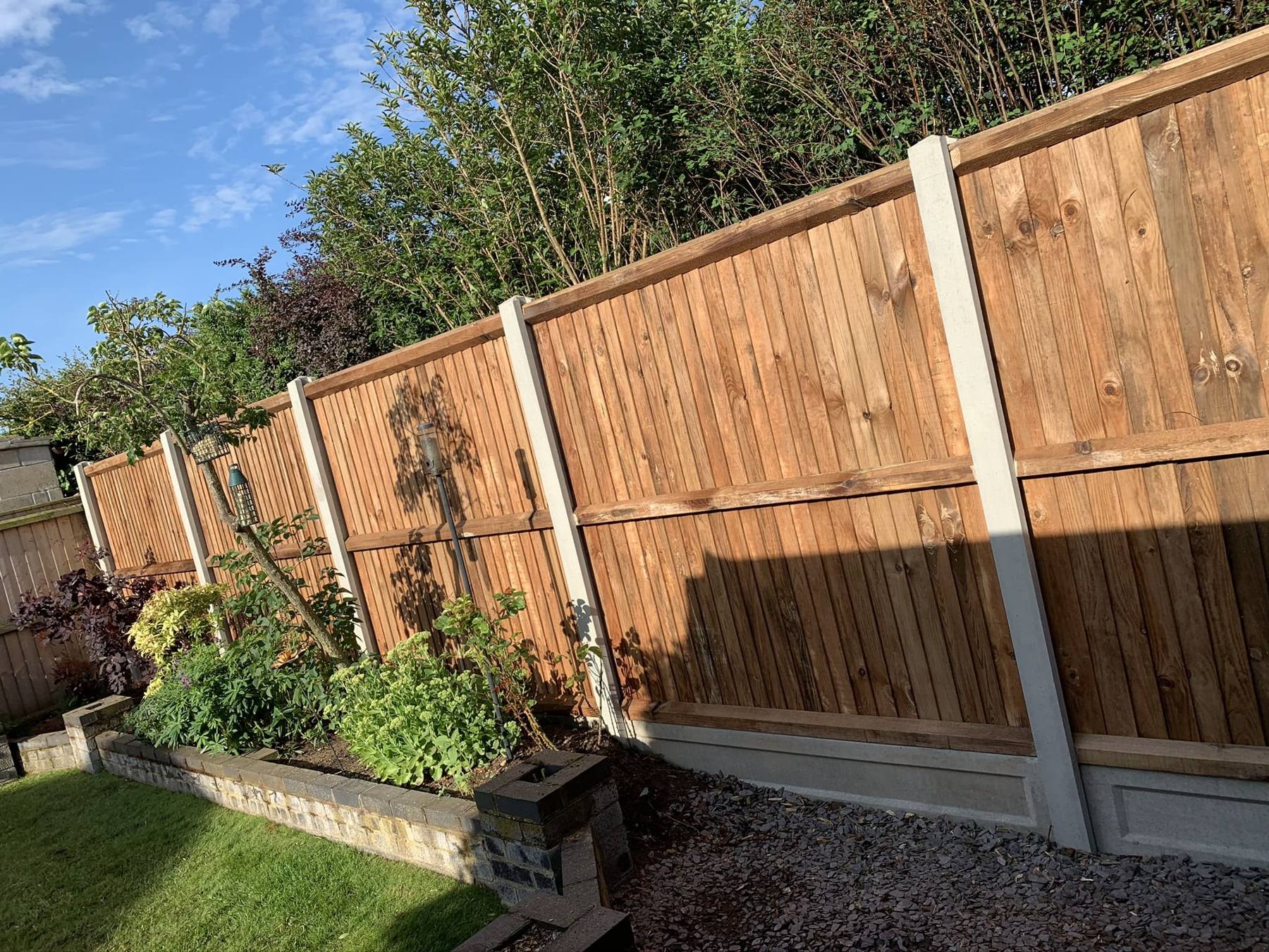 Closeboard fence above a raised planting border