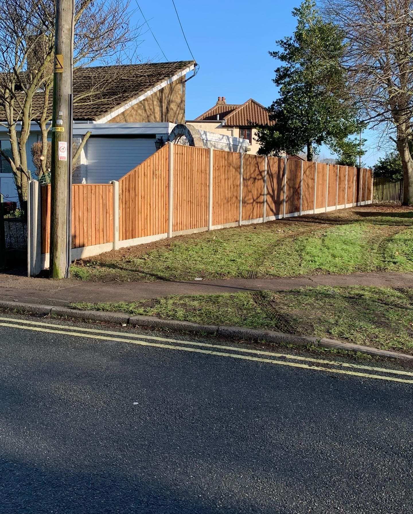 Closeboard fence alongside a road