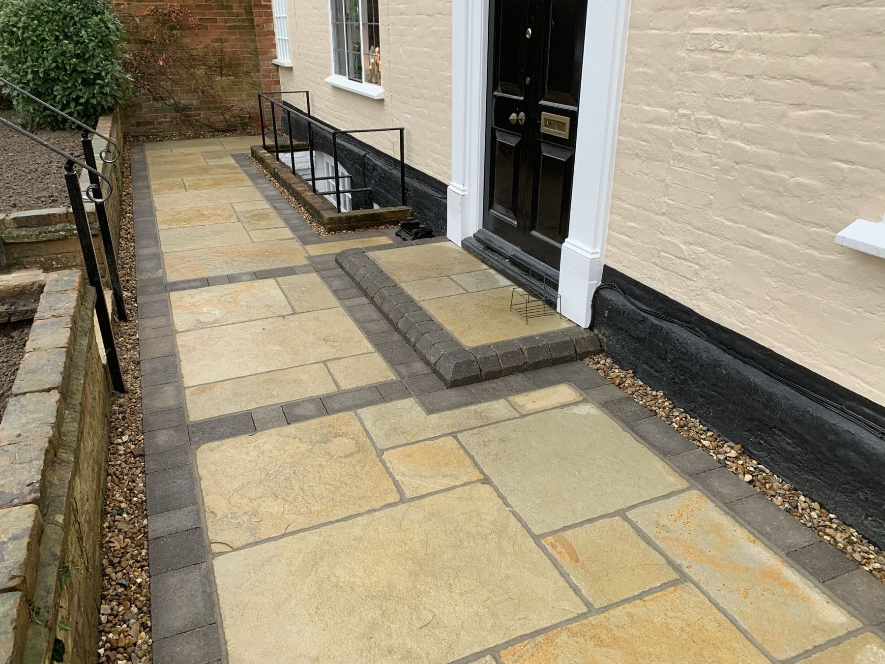 Sandstone front path with steps up to a black front door